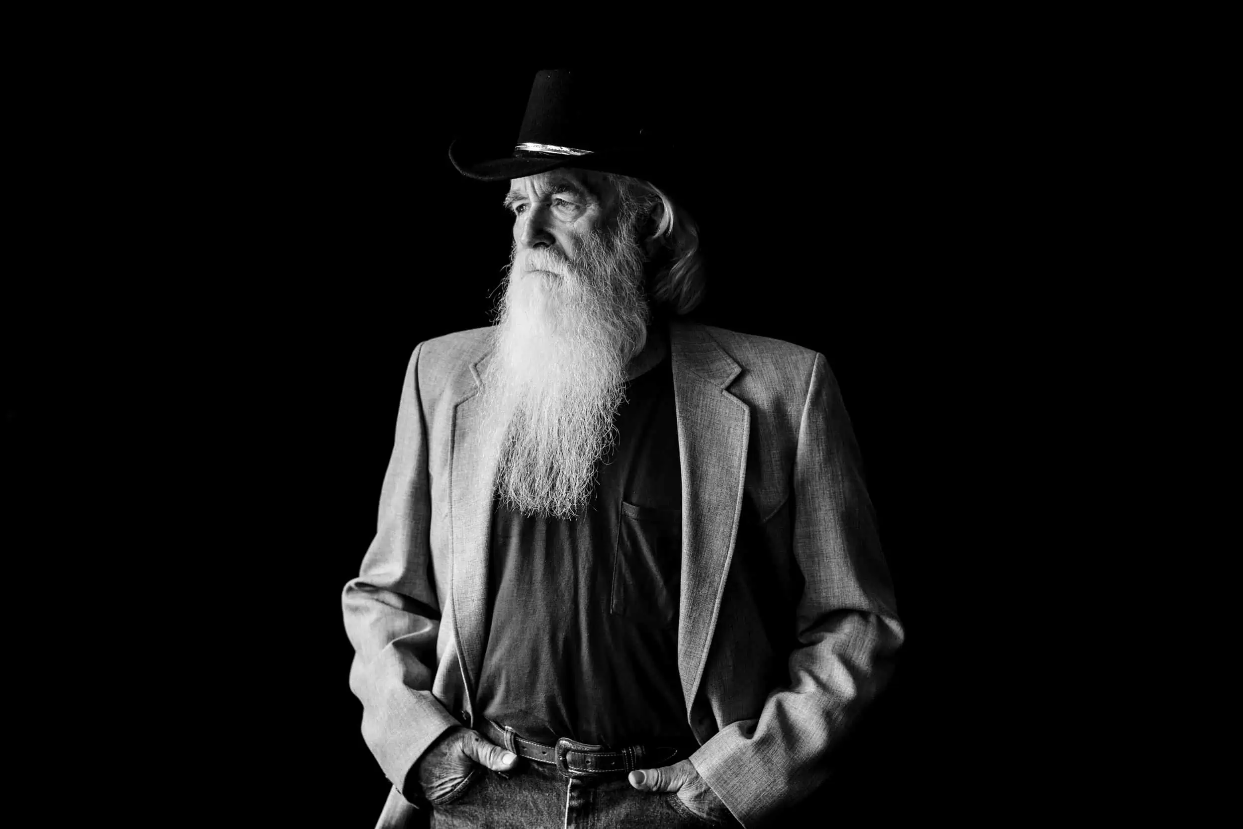 A black and white photo of a man with a long white beard.