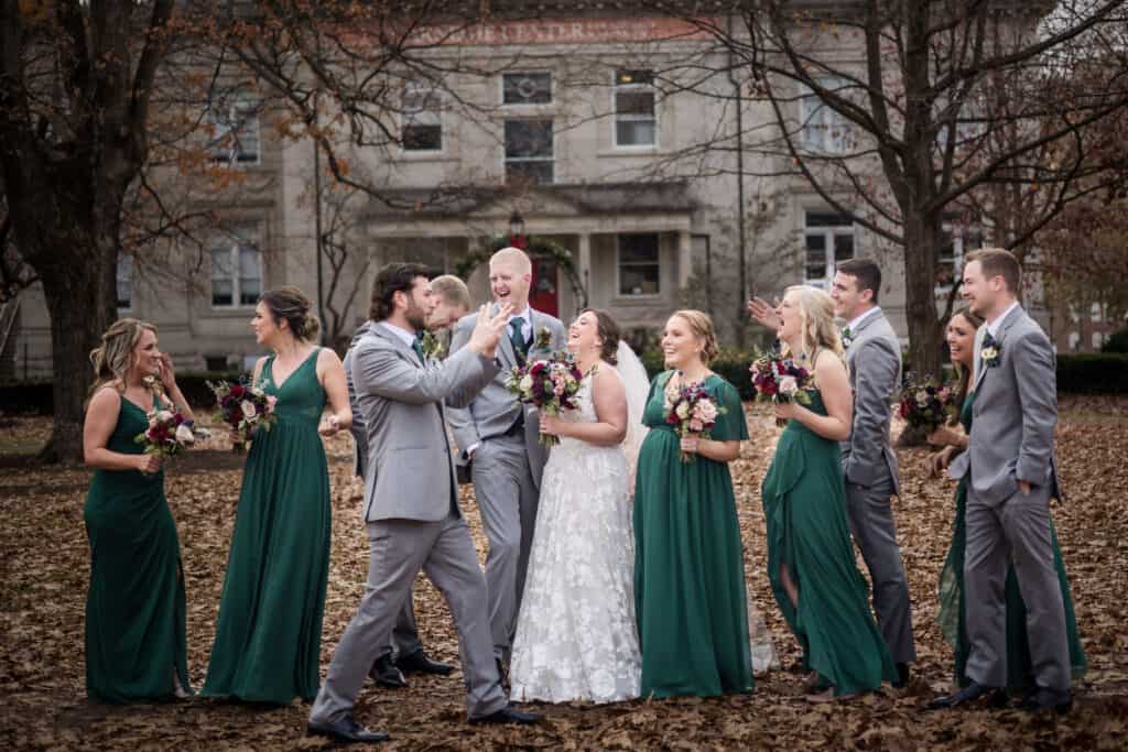 A group of bridesmaids and groomsmen posing.