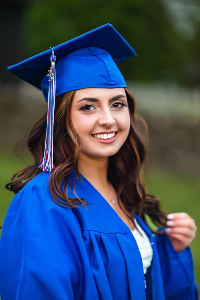Girl Playing With Hair In Cap And Gown Lexington Senior Photographer