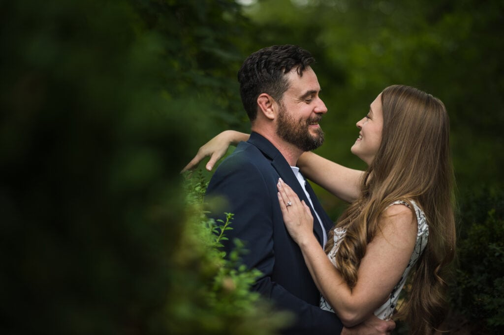 A couple embracing in the woods during their Frankfort KY engagement session.