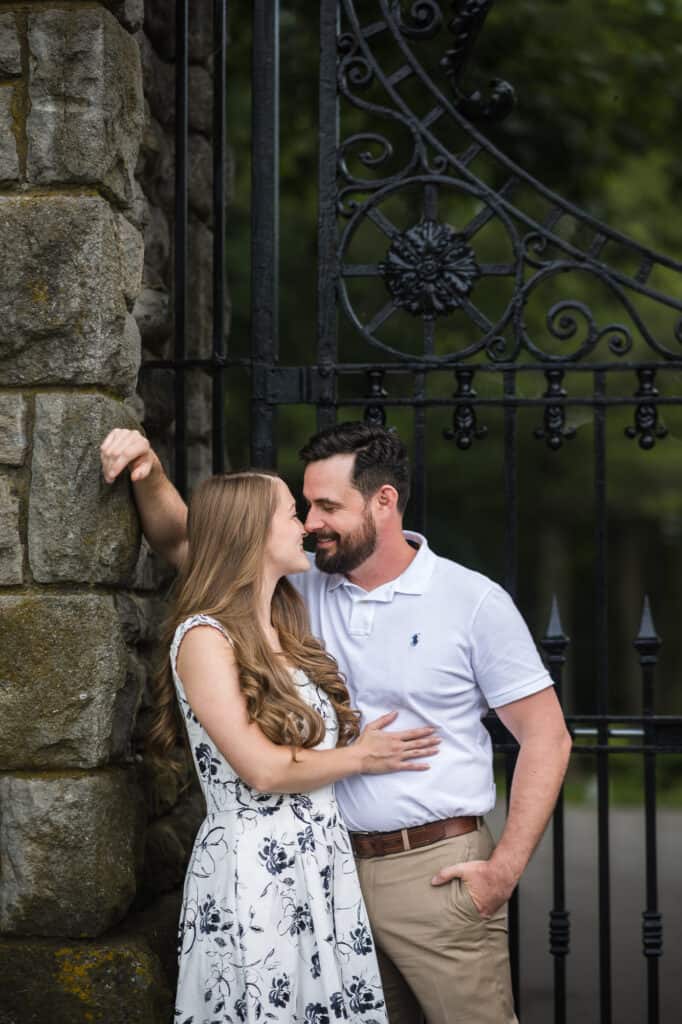 An engagement photo in Frankfort KY featuring a couple kissing in front of a gate.
