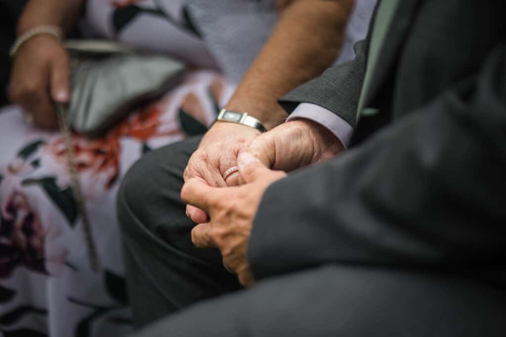 parents holding hands during wedding ceremony in Frankfort Ky