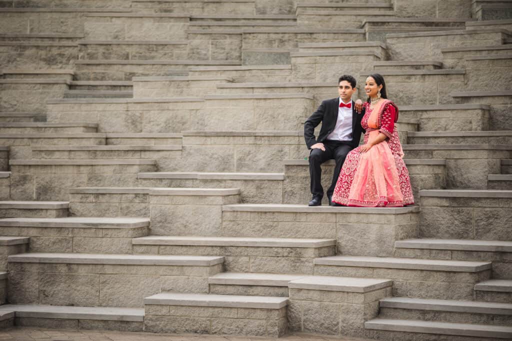 The couple sharing a candid moment on the geometric stairs of the Ali Center, highlighting the urban charm of their Nikkah pre-ceremony portraits in Louisville.