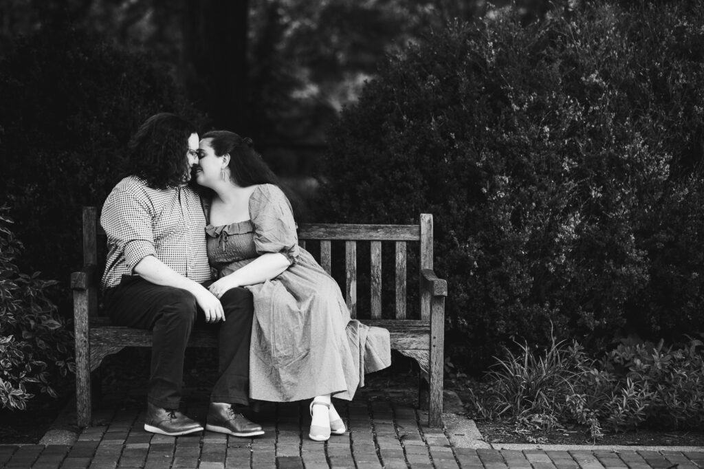 An engagement session capturing a couple's romantic moment on a bench at the UK Arboretum, beautifully rendered in black and white.