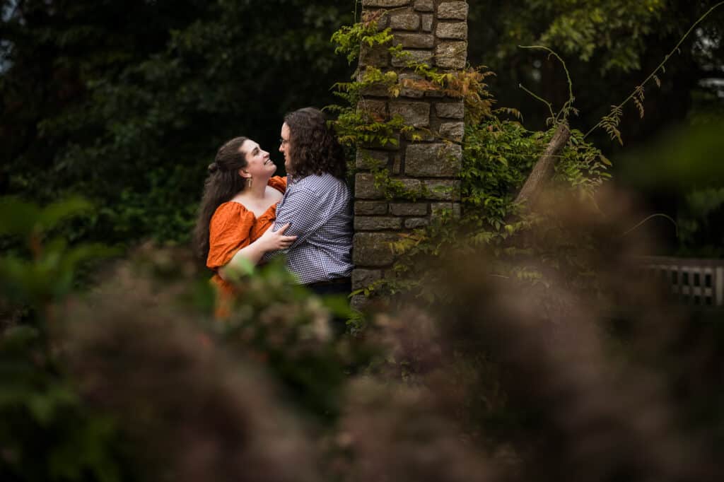 A couple embraces during an engagement session at UK Arboretum.
