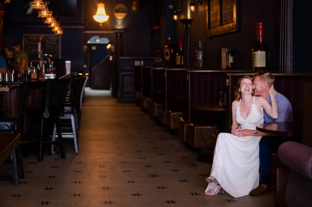 A couple posing for an engagement session at Bourbon on Rye.