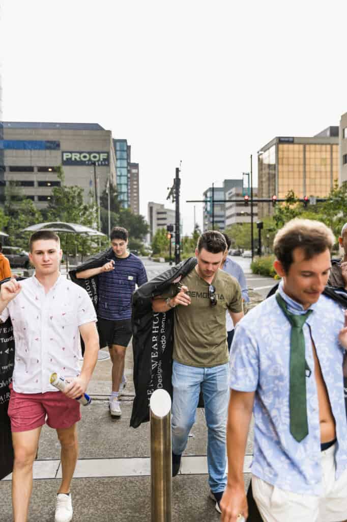 A group of men walking down a street near Harper Hall.