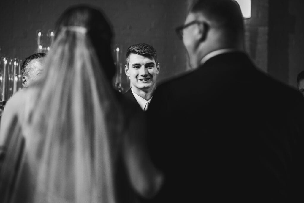 Harper Hall bride and groom exchange glances during their wedding ceremony.