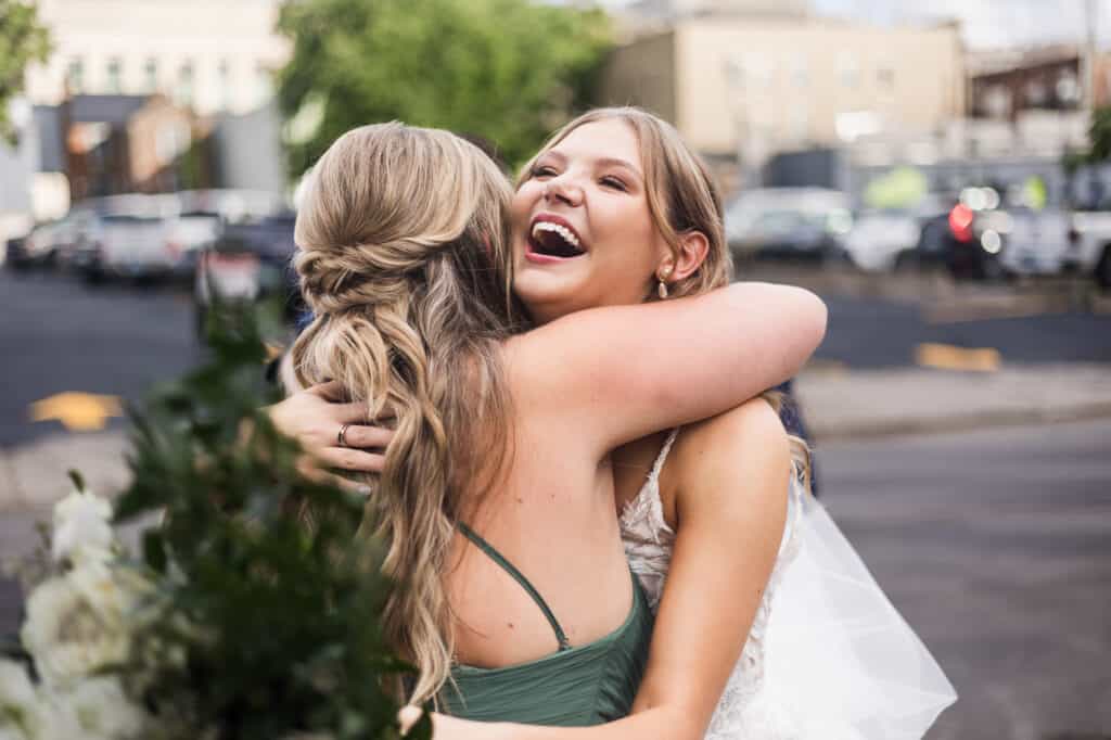 Two brides hugging at a Harper Hall wedding.
