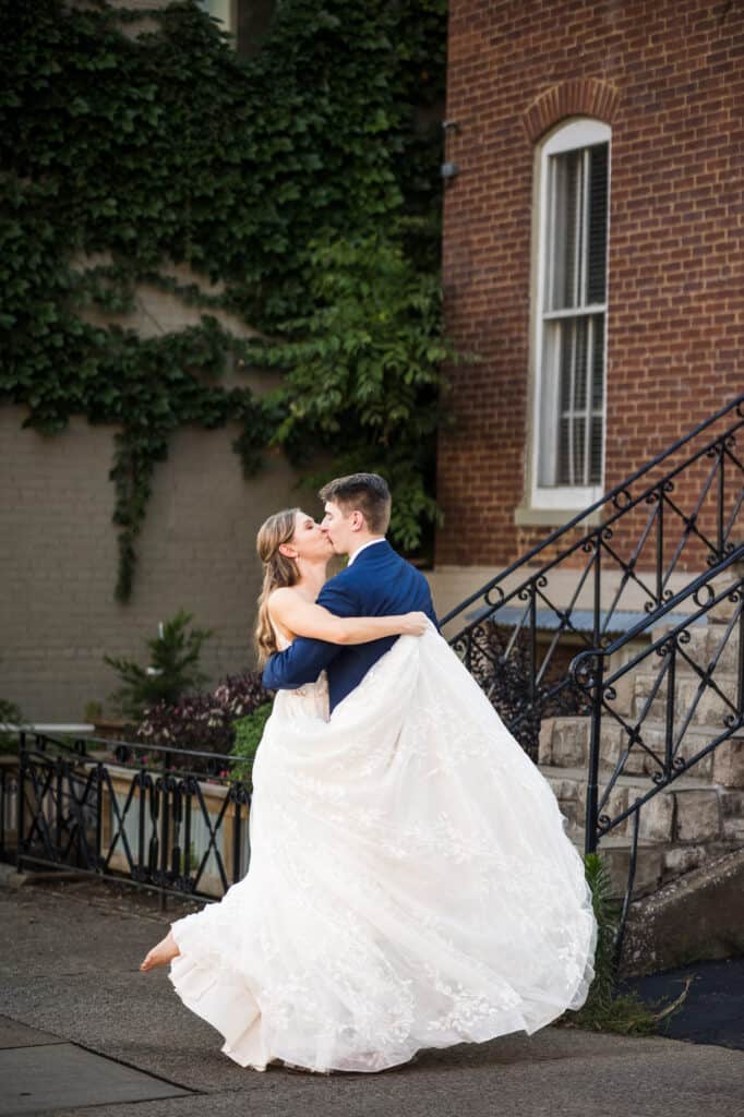 A bride and groom having their first kiss at Harper Hall Wedding.
