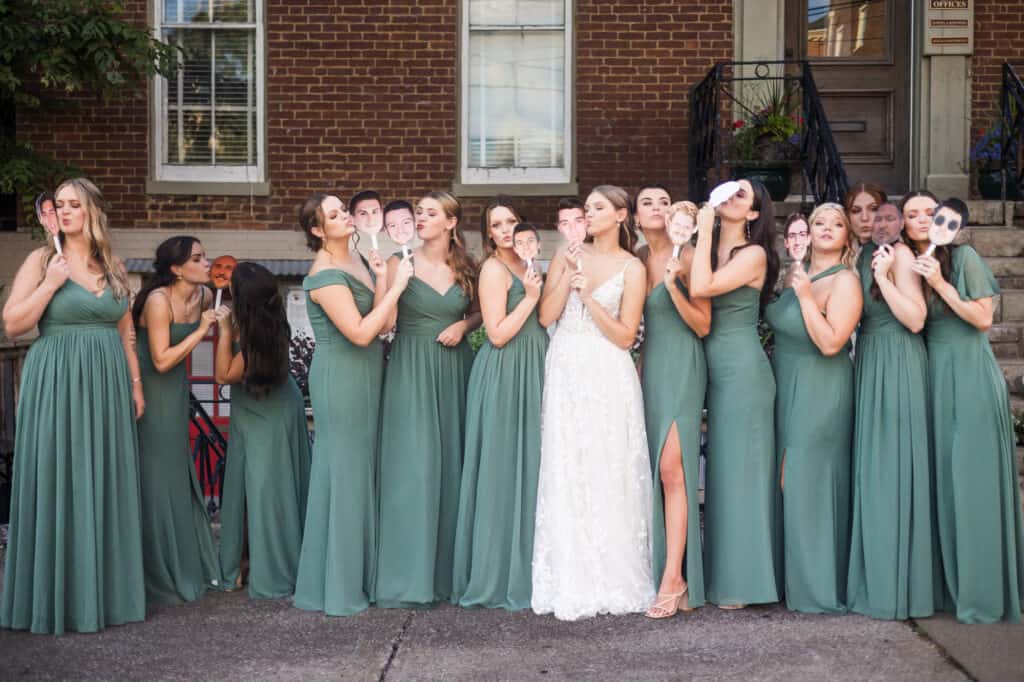 A group of bridesmaids in green dresses pose for a photo at Harper Hall Wedding.