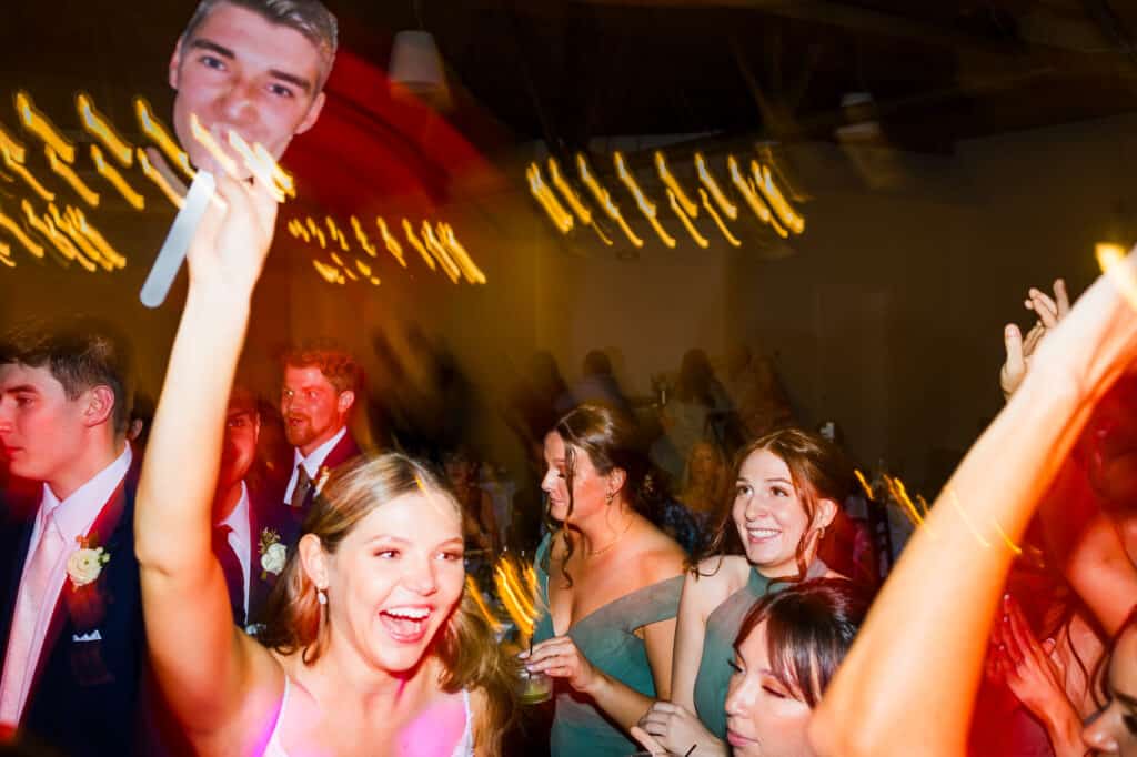 A group of people dancing at a wedding party.