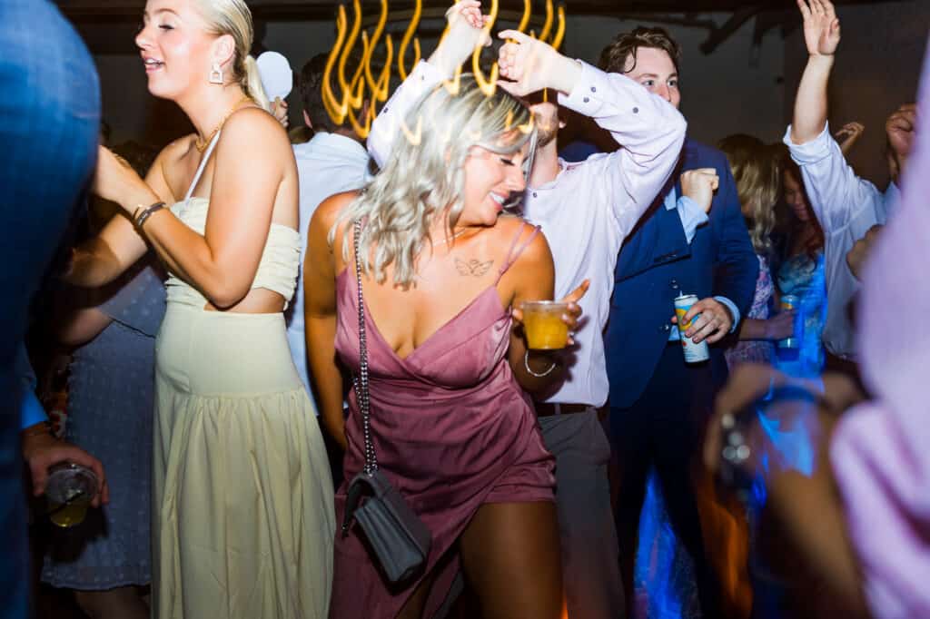 A group of people dancing at a wedding party.