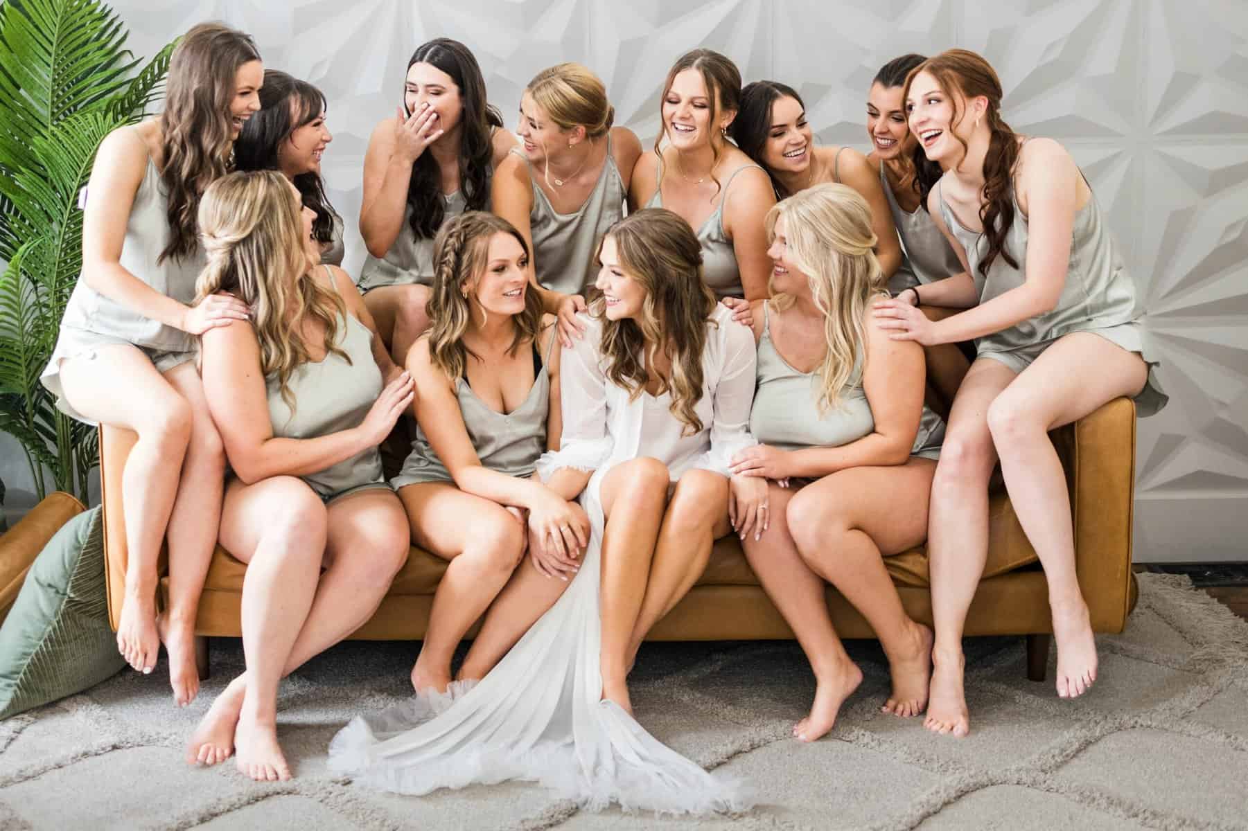 A group of bridesmaids posing on a couch.