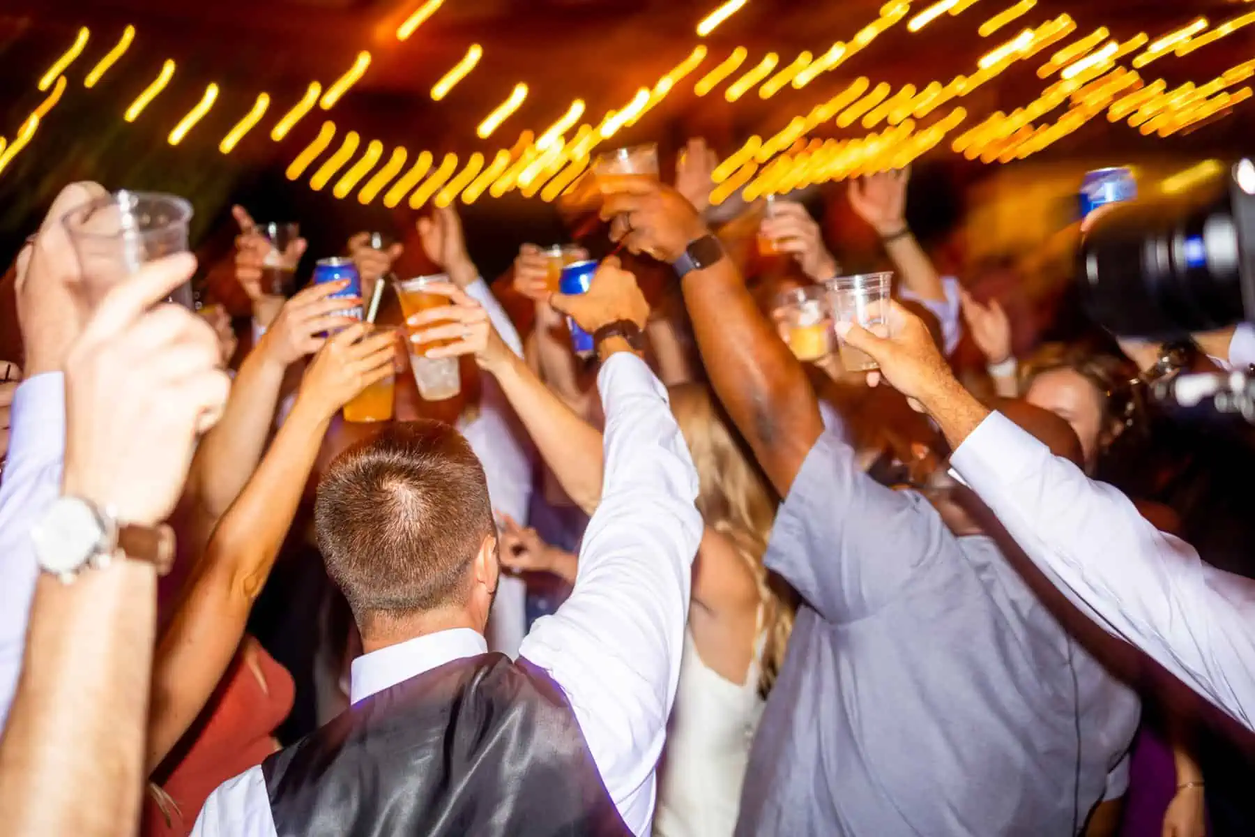 A group of people raising their glasses at a party.