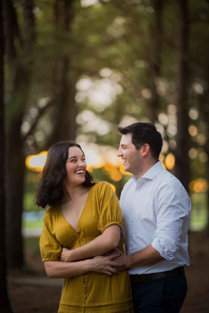 An Engaged Couple At Jacobson Park During Sunset For Engagement Photos.
