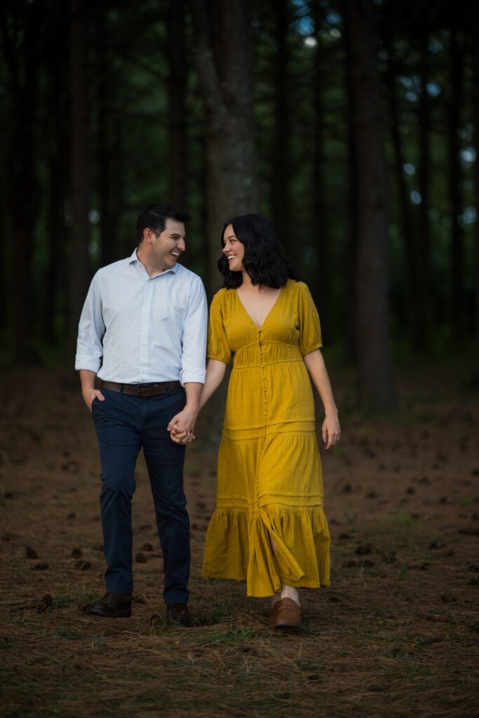 A Couple Holding Hands In Jacobson Park During Their Engagement Session.
