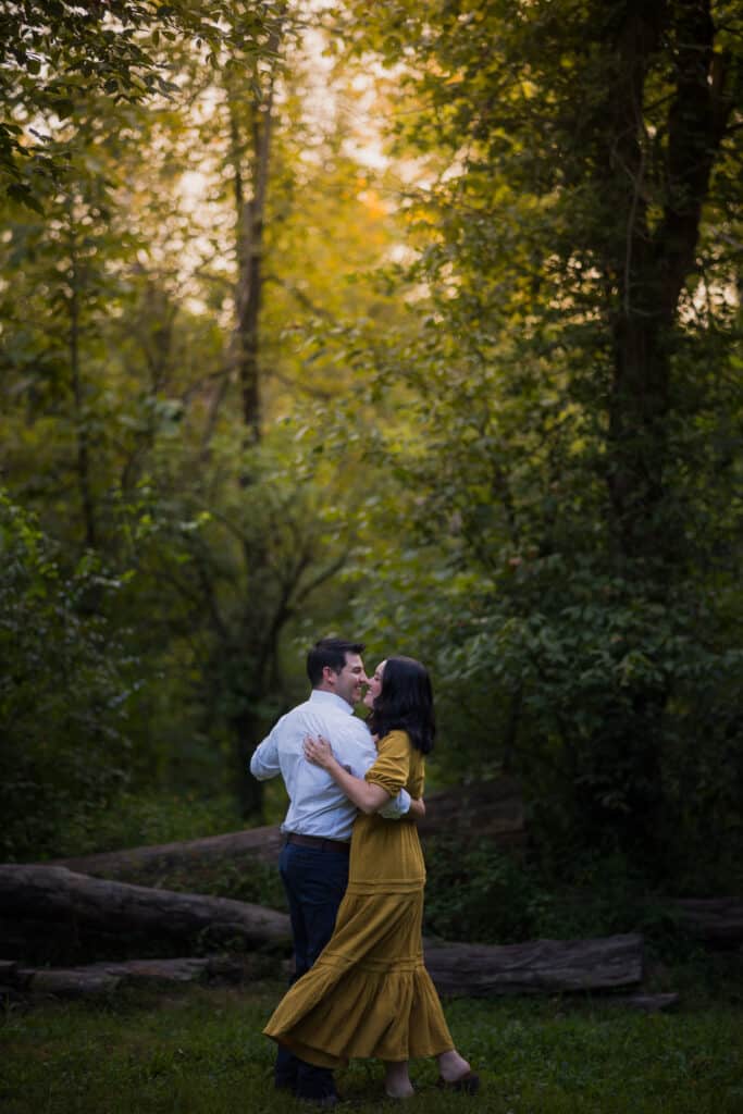 Jacobson Park Engagement Session Captures A Couple Embracing In The Woods.