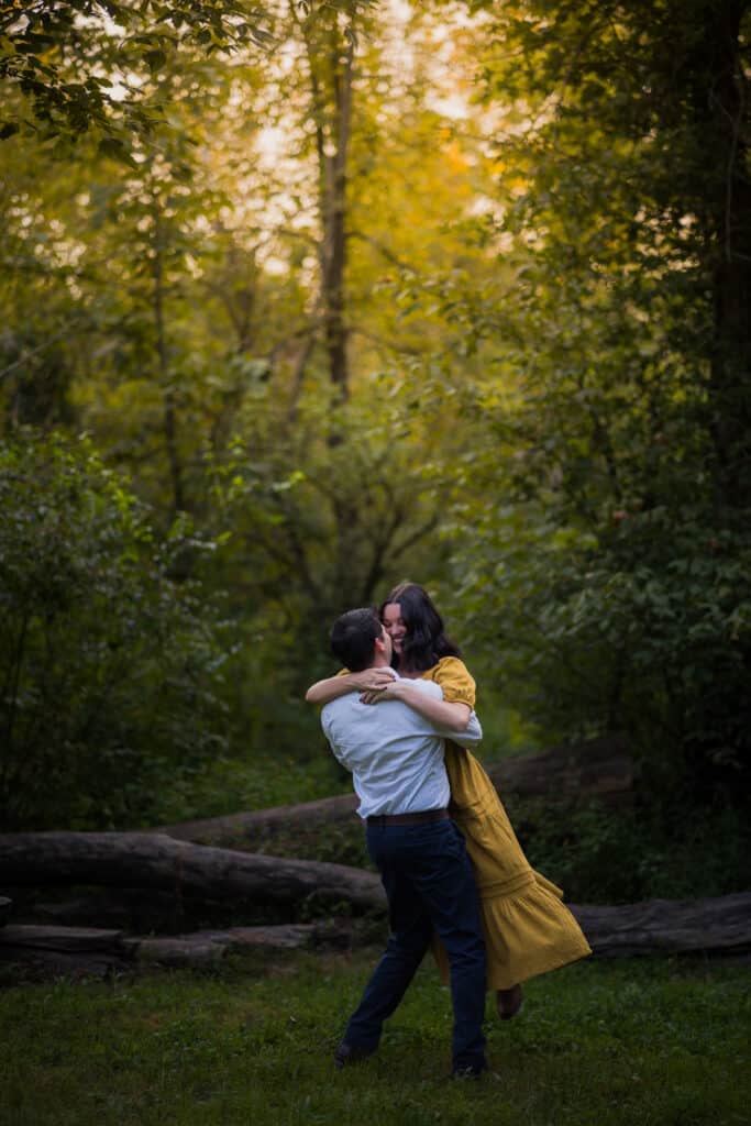 Jacobson Park Engagement Photos - An Engaged Couple Hugging In The Woods.