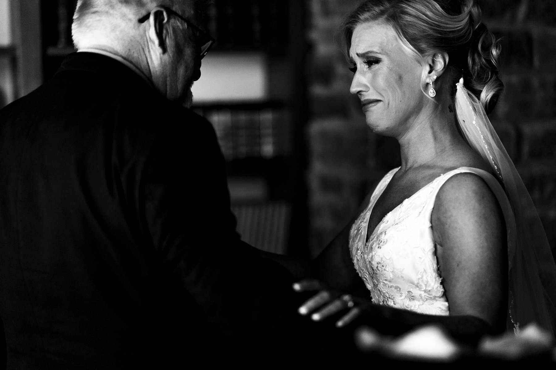 A black and white photo of a bride and her father.