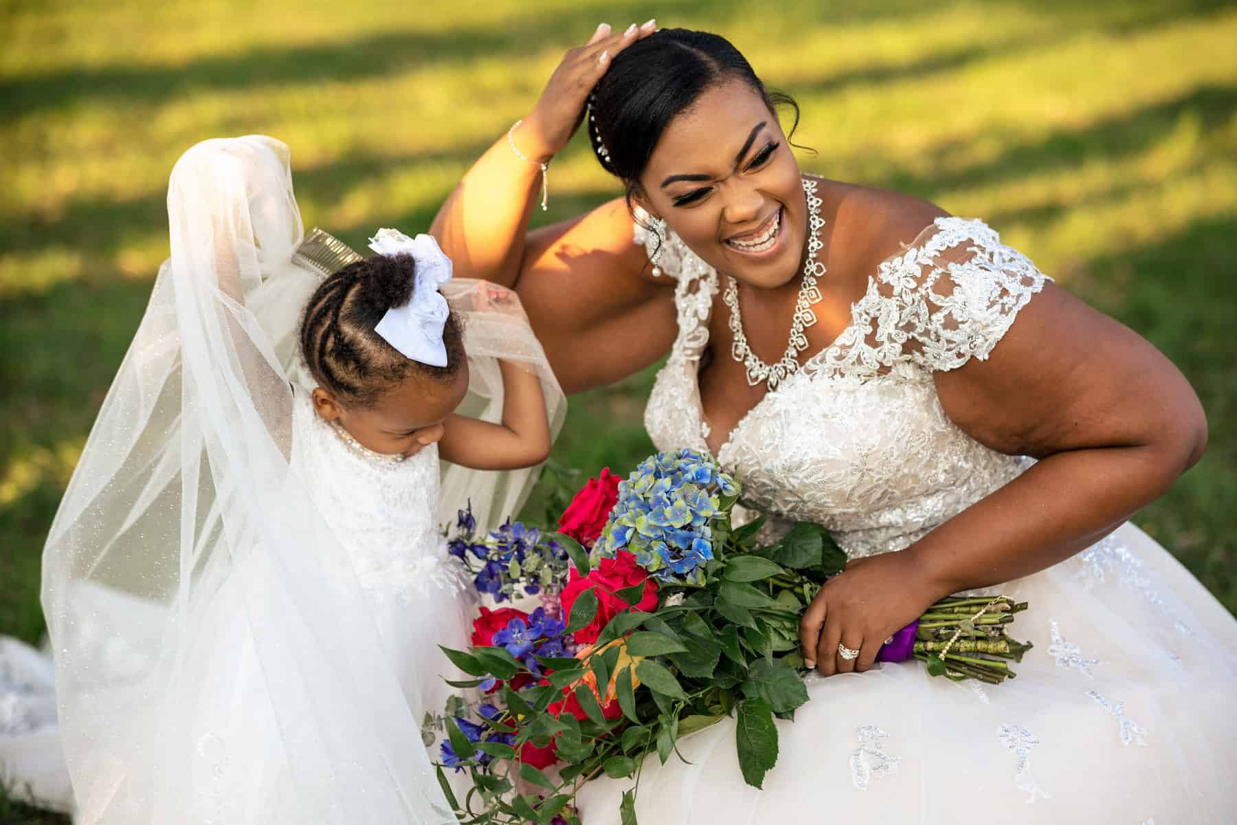 A bride and her daughter in a field.