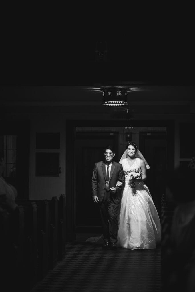 A Bride And Groom Walking Down The Aisle Of A Church During Their Micro Wedding In Lexington, Ky.