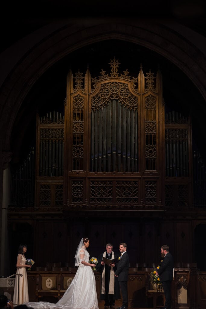 A Micro Wedding Featuring A Bride And Groom Standing In Front Of A Pipe Organ In Lexington, Ky.