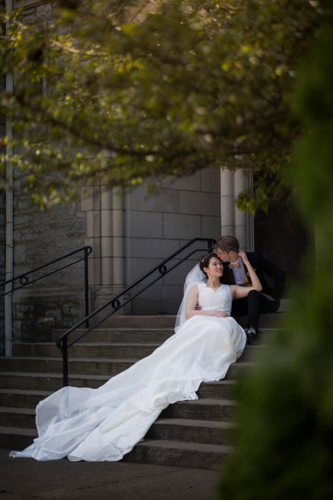 A Couple Sitting On The Steps Of A Church During Their Micro Wedding In Lexington, Ky.