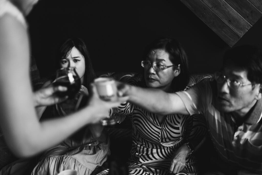 A Black And White Photo Of A Group Of People Drinking Wine At A Micro Wedding In Lexington, Ky.