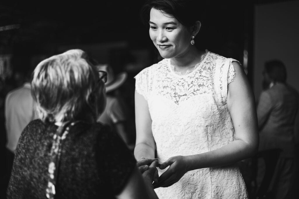 A Black And White Photo Of A Woman Talking To Another Woman At A Micro Wedding In Lexington, Ky.