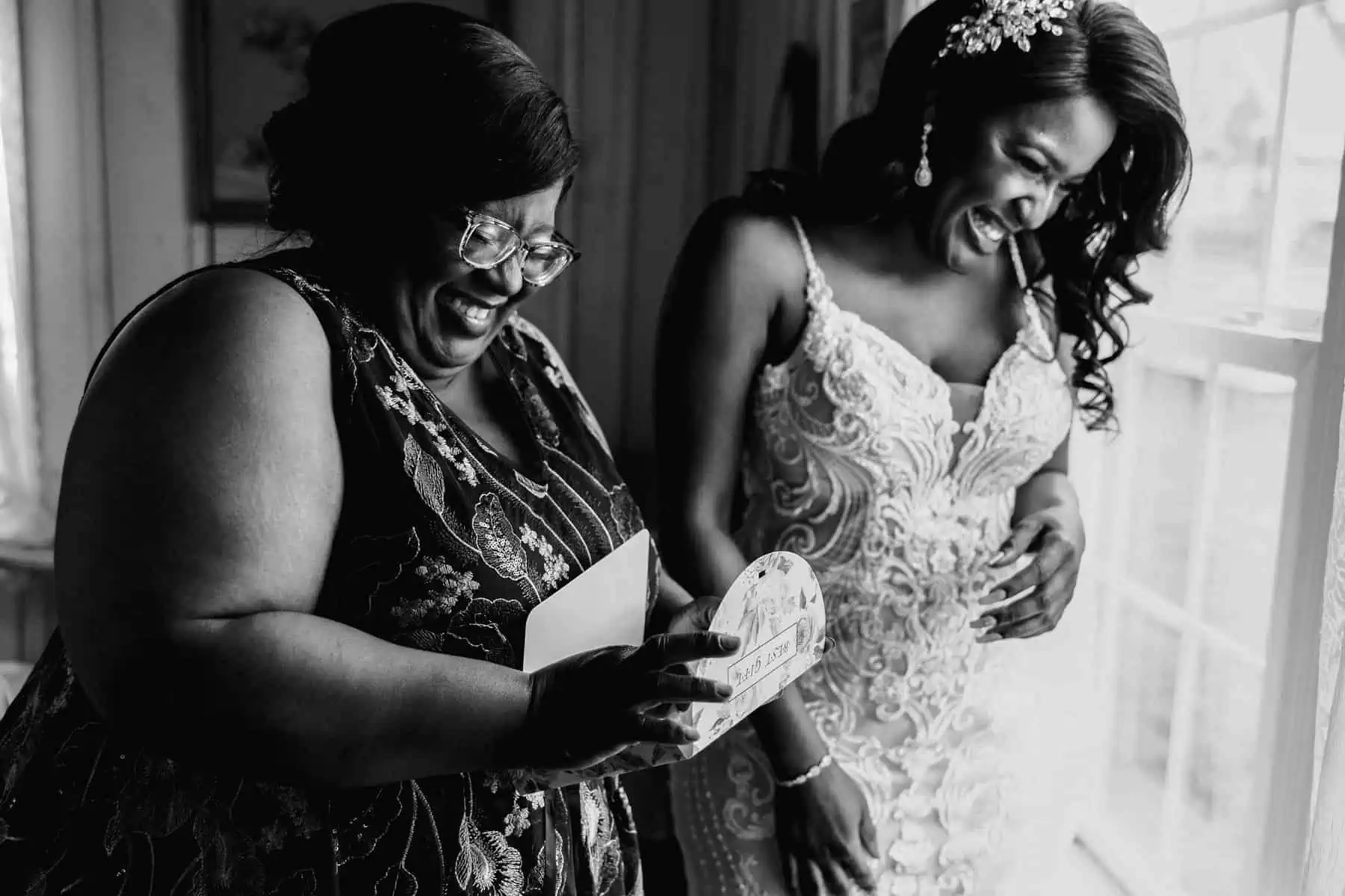 A black and white photo of a bride and her mother.
