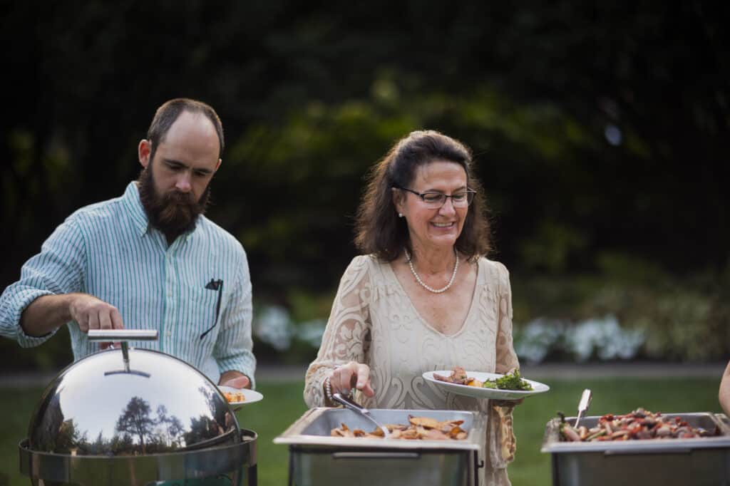 Kentucky event photography capturing a group of people serving food at an outdoor event.