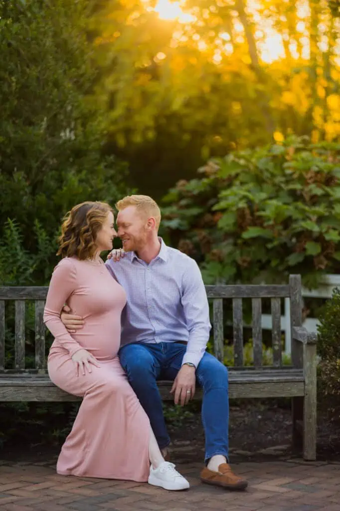 A couple poses on a bench during their maternity session with their Lexington KY Maternity Photographer.